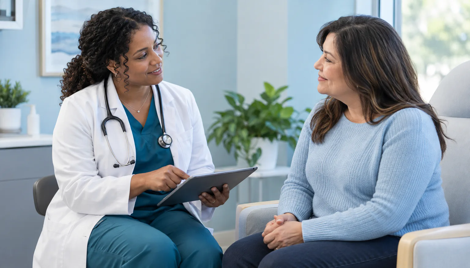 A primary care provider listening to a patient during a membership visit at Palm Wellness Center