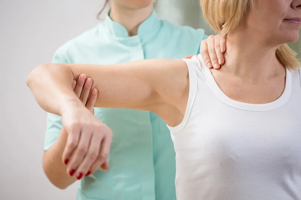 Therapist guiding a patient through a controlled therapeutic movement