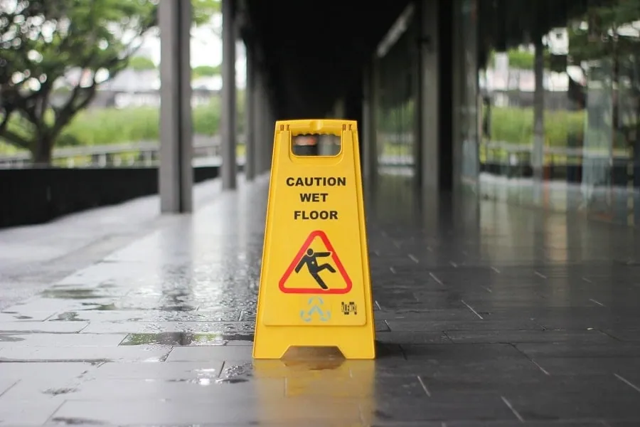 A wet floor caution sign representing slip and fall injuries